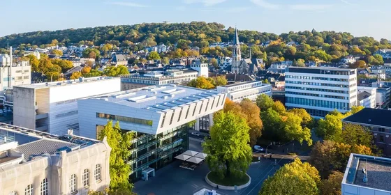 Scenic aerial view of the RWTH Aachen University campus surrounded by greenery, showcasing its modern and vibrant infrastructure.