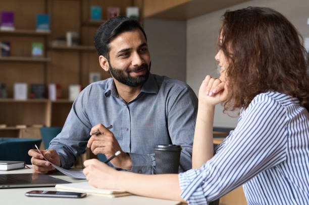 Formal academic consultation between Pakistani student and German professor demonstrating professional communication